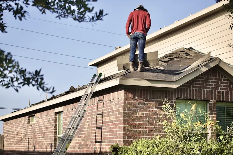 Professional roofer working on a residential roof in Oak Hill Farms